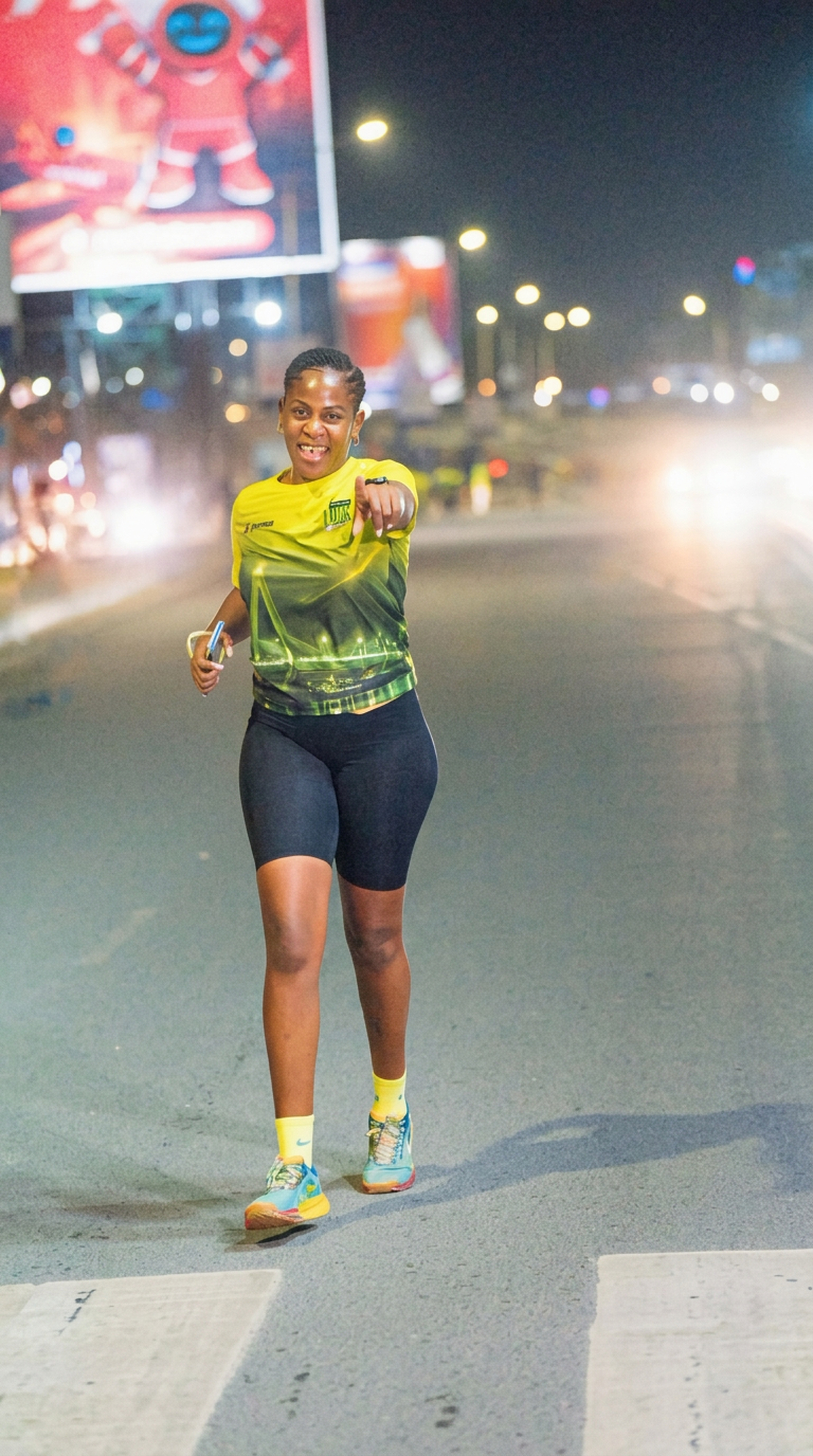 Runner pointing to the camera on a Dar es Salaam road at night